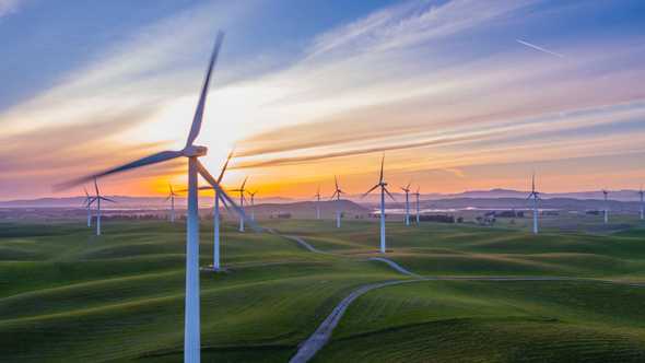 Modern wind mills on a field. Metaphor for wind like in Tailwind.